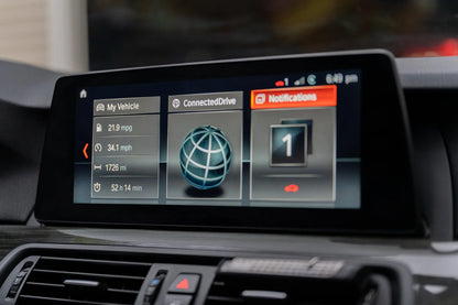 NBT EVO retrofit F series BMW displayed on car screen with vehicle information and notifications.