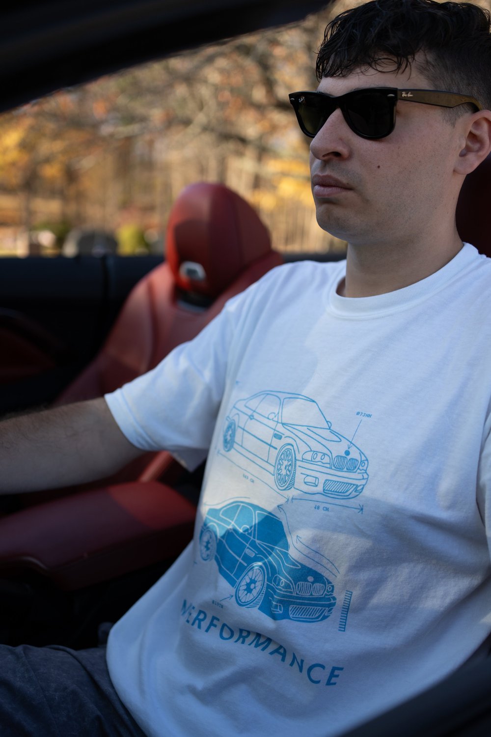 E46 M3 graphic t-shirt worn by a person in a car, showcasing a retro design and classic style.